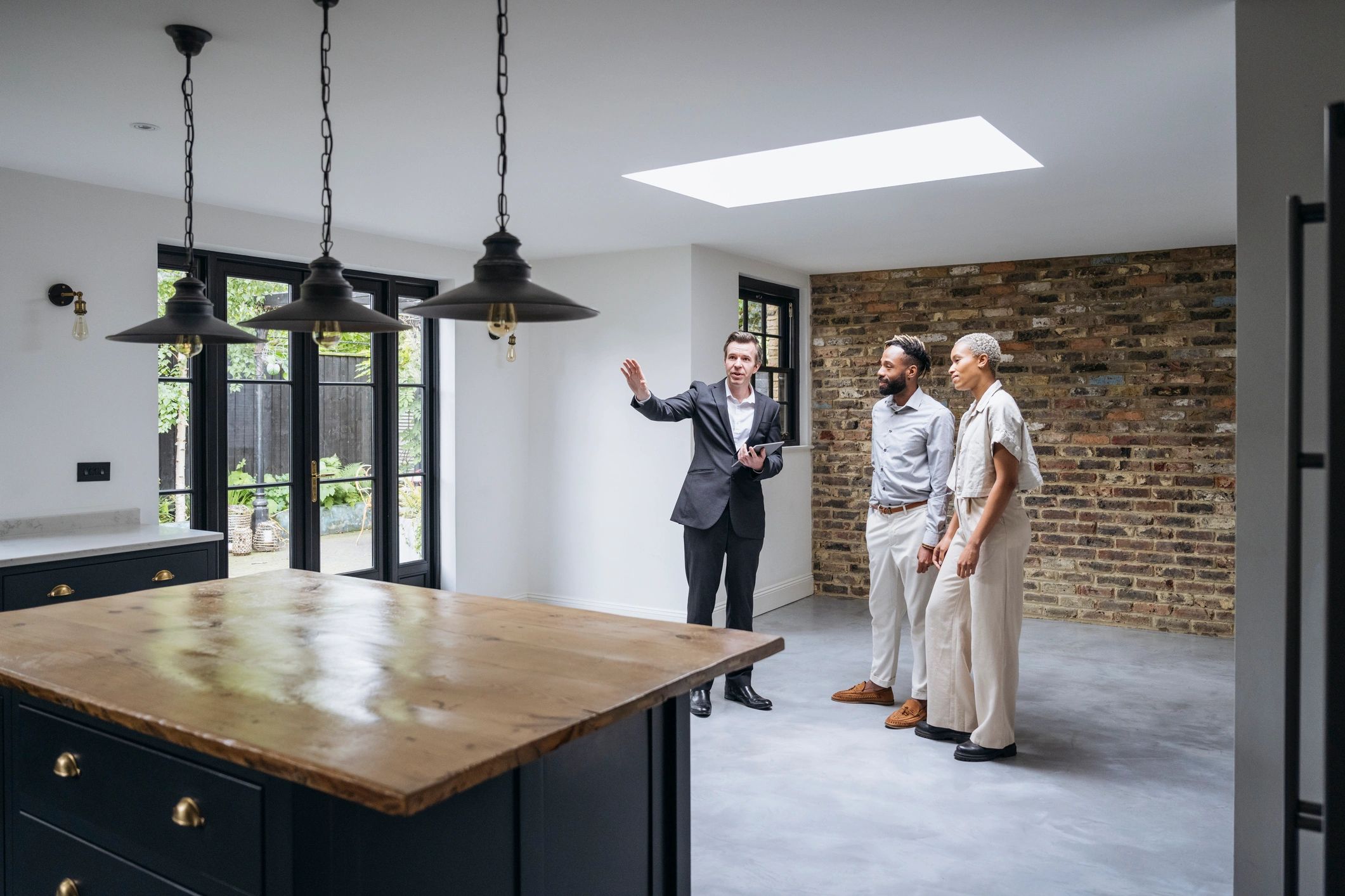 Real estate agent showing a home to prospective buyers