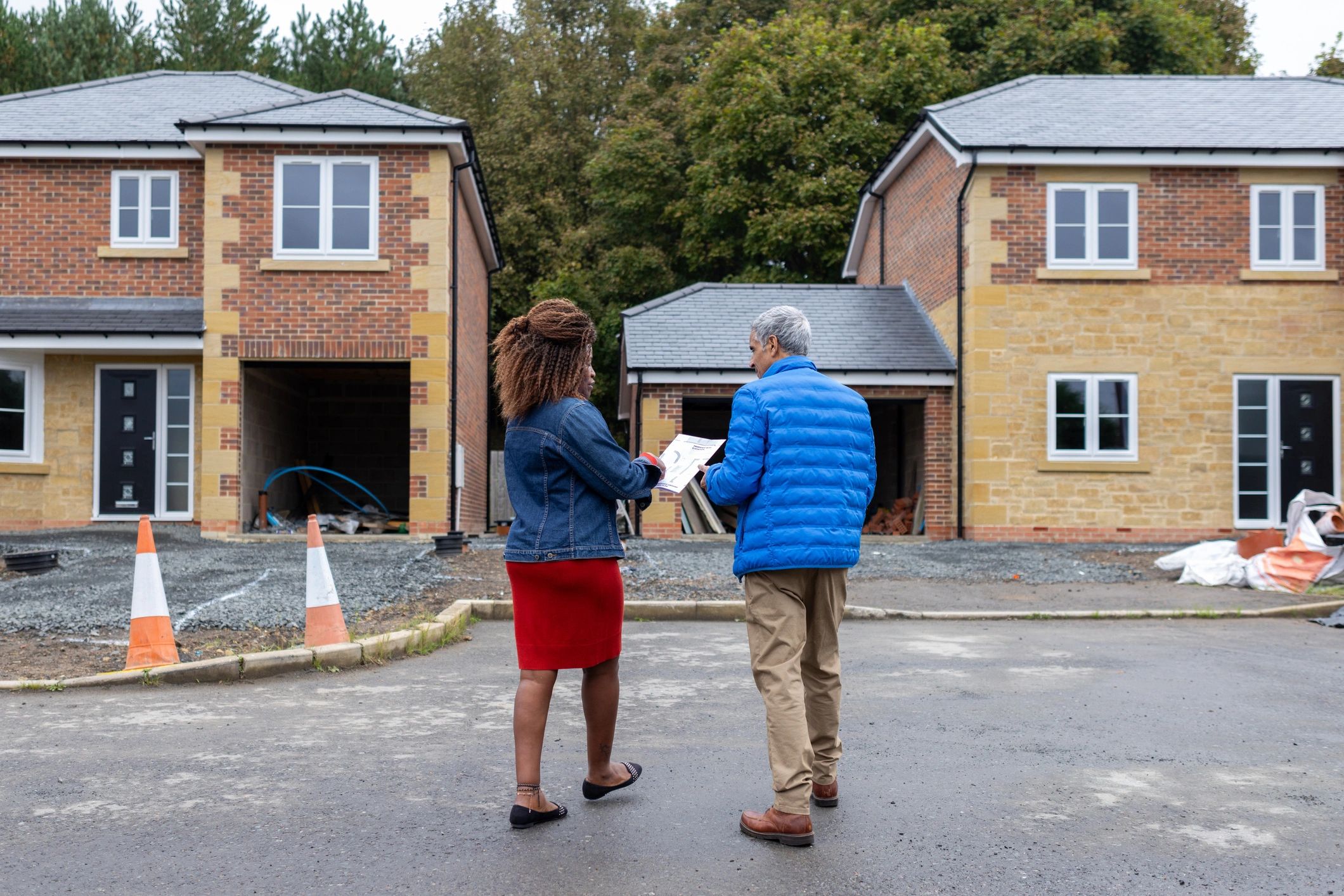 Real estate agent meeting clients to review plans and next steps