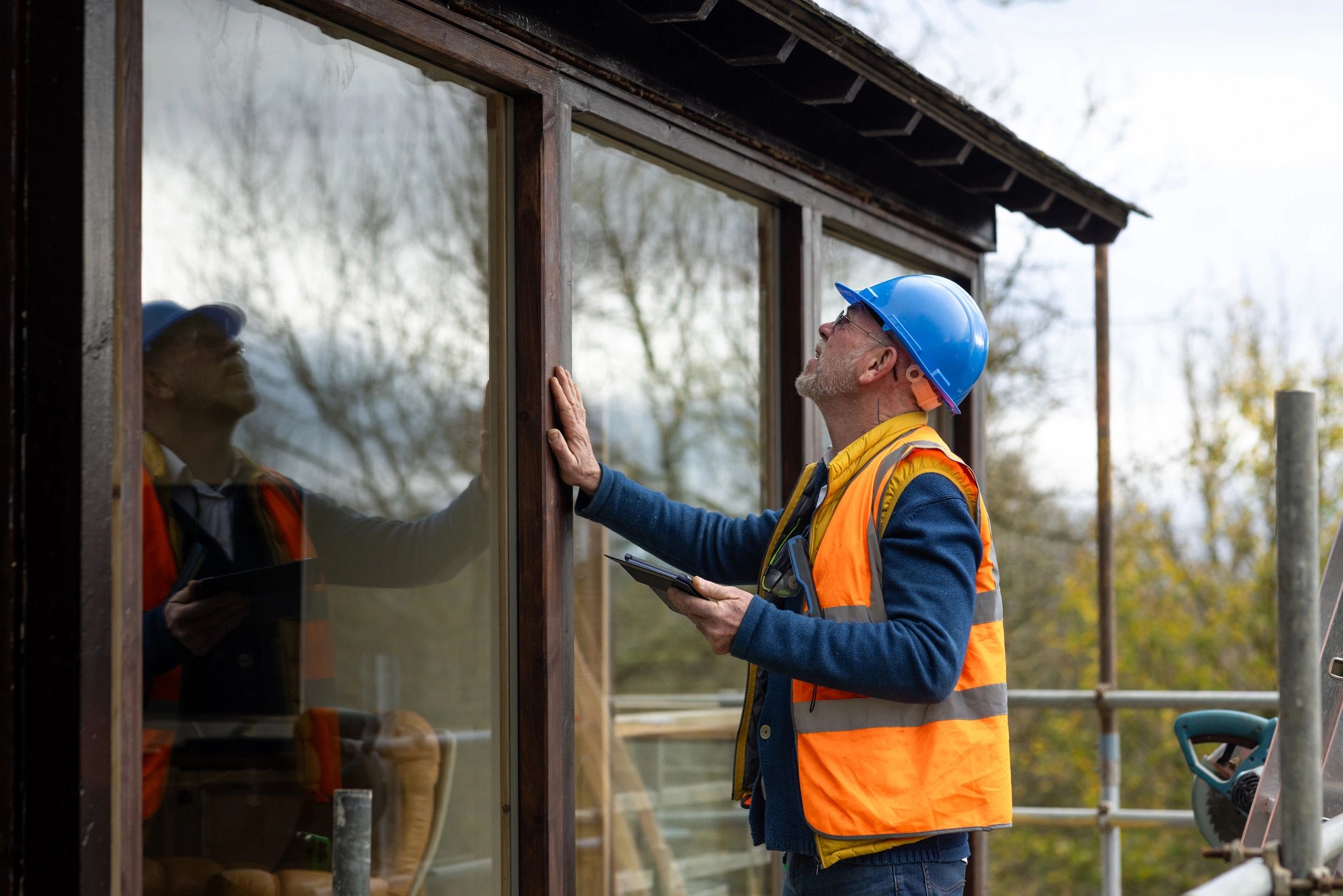 Home inspector reviewing exterior details with a clipboard