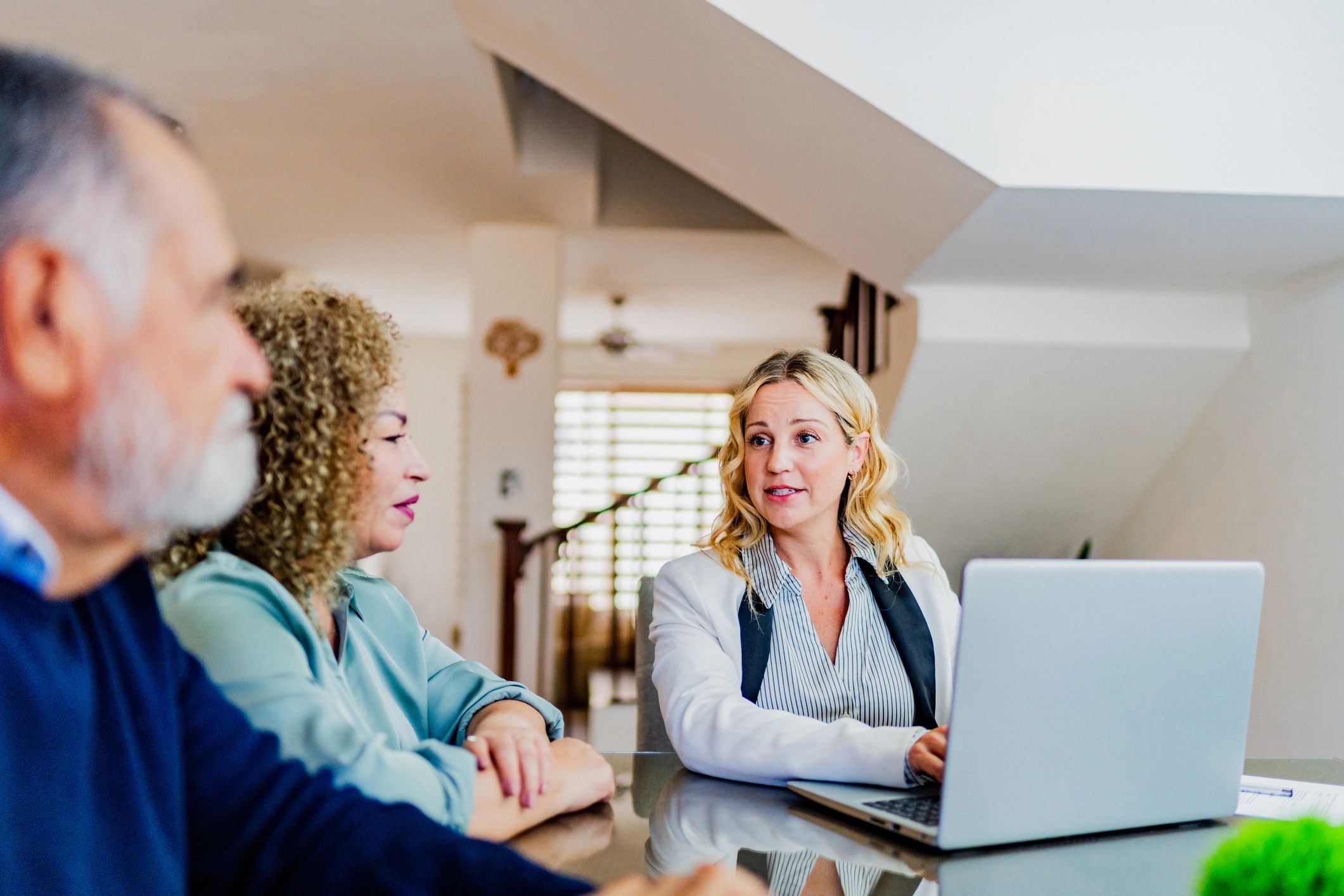 Real estate professional meeting with clients at home